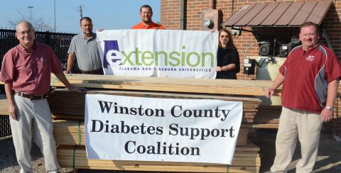 From left, Former Winston County Extension Agent Mike Henshaw, HCT Drafting Instructor Jamie White, Extension Coordinator Zack Brannon, Assistant High School Principals Candy Garner and John McCullar with $2,000 worth of lumber donated by Mill Creek for the project.