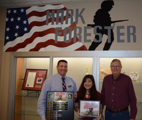 From left, Haleyville High School Principal Davey Reed, art student Anna Reyes and Ray Forester are proud of the new  trophy case and patriotic mural honoring Ray's son, Senior Airman Mark Forester, who was killed in the line of duty in 2010.