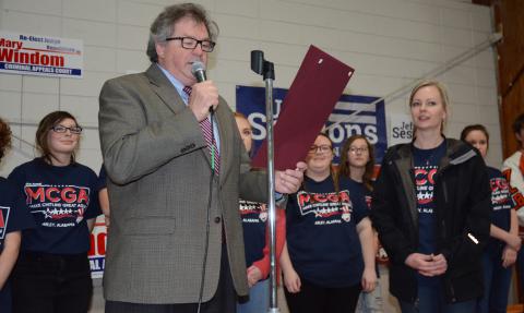 State Representative Tim Wadsworth reads the state resolution honoring the Meek High School band. Shown looking on are band students and MHS Principal Marla Murrah.
