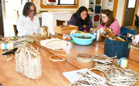 Instructor Sarah Bell of Birmingham (center) and two students make mimosa bark baskets during the April session of Alabama Folk School at Camp McDowell.