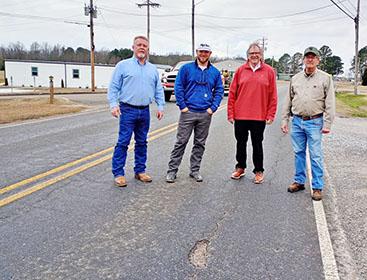 A five-mile section of County Road 77 (also known as Helicon Road) from County Road 41 in Arley will be resurfaced, thanks to $2 million in state funding. Shown at a deteriorating section of County Road 77,  from left, Arley Mayor Johnny Taylor, Winston County District 1 Commissioner Rutger Hyche, State Representative Tim Wadsworth and Arley Fire Chief James Rickett.