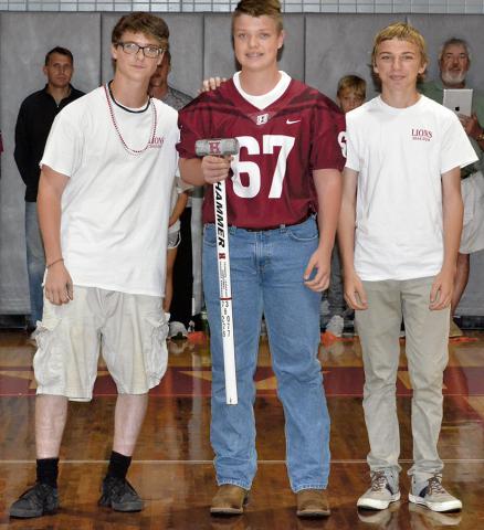 The Haleyville High School Band and booster organization present a HHS football player at each pep rally  with the Hammer Award. Pictured above is recipient Cade Burleson. Making the presentation are band members Matthew Arnall, left, and Michael Atkins.