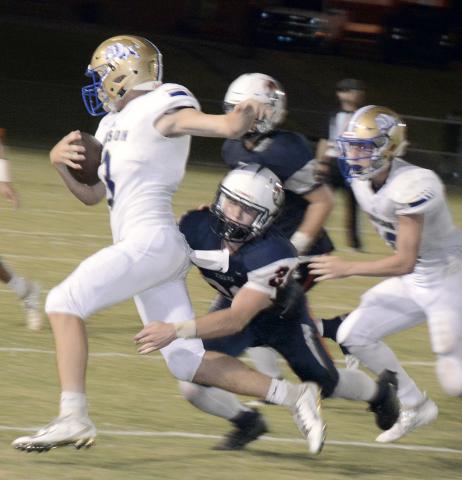 Logan Wilkins carries the ball for Addison.