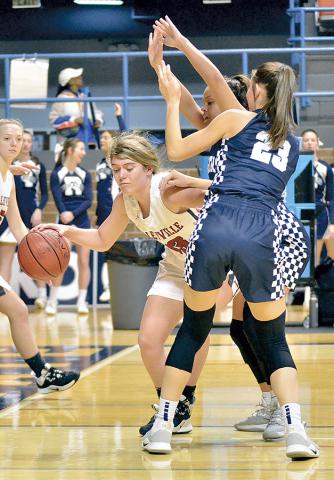 HHS leading scorer Catie Aldridge fights her way around double coverage.