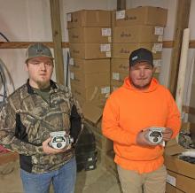 Bear Creek Water Department Employees Ethan Stone, right, and Kevin Hyde show the new water meters that are being stored at the water warehouse until they can be installed after the town’s water leak situation is brought further under control.