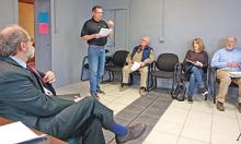 Benjamin Grizzell. standing, owner of Smith Lake Rentals and Sales, addresses the Winston County Commission with concerns about the proposed lodging tax. At left is Commission Attorney Jeff Mobley. At right is George Gibson, Karen and Charlie White, who also spoke out with concerns.