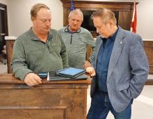 From left, Winston County Commission Chairman David Cummings, Haleyville EMA Director Phillip Weaver and Haleyville Mayor Dr. Ray Boshell review weather forecasts during a weather preparedness meeting Wednesday.