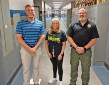 From left, Addison High School Principal Scott Flynn, Addison Elementary Principal Cindy Hastings and new school resource officer Andrew Wray in the hallways of the  high school.