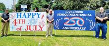 From left, Addison Assistant Police Chief Greg Rooks, Assistant Fire Chief Brent Porter and Police Chief Mitchell Woodard at one of the many patriotic displays in the town preparing for this Saturday's July 4 parade and fireworks show.