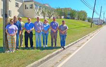 Haleyville officials gather  where the new sidewalk will be constructed. From left, City  Clerk Christy Harbin, city council members Todd Barton and Cade Lewis,  Mayor Dr. Ray Boshell, council members Brian Berry and Boo Brooks, Director of Public Works Chris Wilbanks and Street and Sanitation Supervisor Chris Saylor.