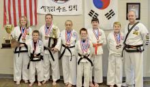 Medal winners from l-r:  Susanne Belew, Nick Galloway, Dale Galloway, Amanda Galloway, Eli Miller, Noah Ray and Caden Cummings and chief instructor Tom Jones.